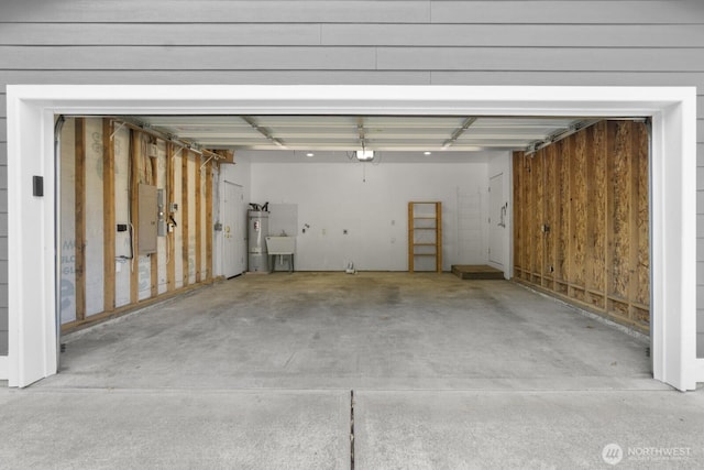 17701 Vine Ln SE, Yelm, WA 98597 - garage featuring a garage door opener, electric panel, and secured water heater