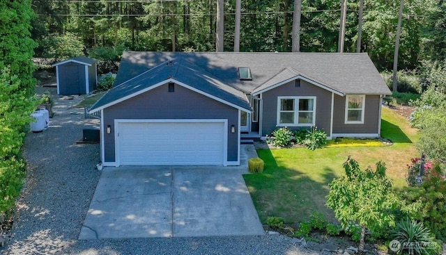 17701 Vine Ln SE, Yelm, WA 98597 - view of front of home with an attached garage, concrete driveway, a storage shed, and a front yard