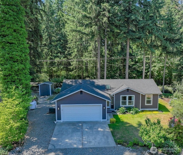 17701 Vine Ln SE, Yelm, WA 98597 - view of front of property featuring an attached garage, a front lawn, concrete driveway, a shed, and a view of trees