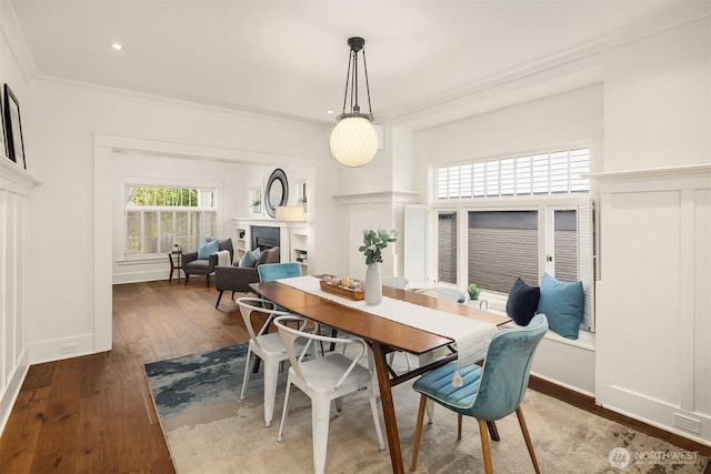 5526 34th Ave NE, Seattle, WA 98105 - dining space featuring hardwood / wood-style floors, ornamental molding, and a fireplace