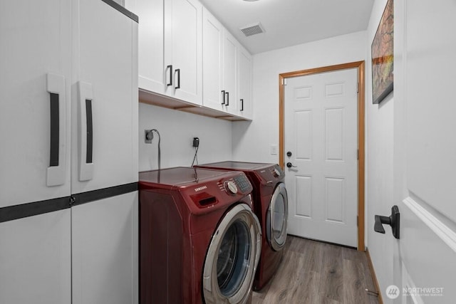 37509 21st Ave S, Federal Way, WA 98003 - washroom with cabinet space, independent washer and dryer, and wood finished floors