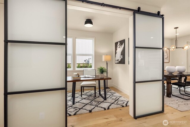 819 18th Ave W, Kirkland, WA 98033 - home office with light wood-type flooring, a barn door, and a chandelier