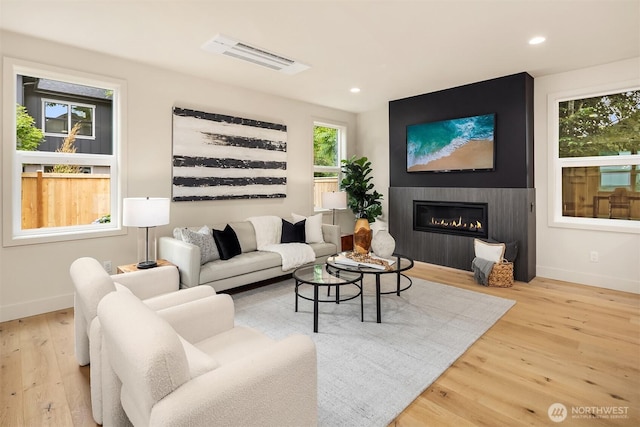 819 18th Ave W, Kirkland, WA 98033 - living area featuring wood finished floors, a large fireplace, and recessed lighting
