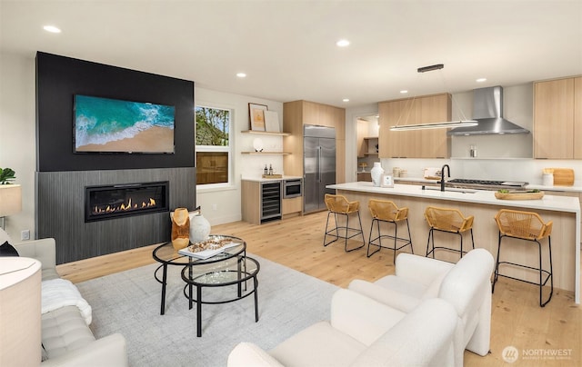 819 18th Ave W, Kirkland, WA 98033 - living area featuring wine cooler, light wood finished floors, recessed lighting, and a large fireplace