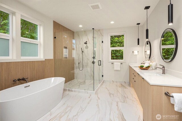 819 18th Ave W, Kirkland, WA 98033 - bathroom featuring a marble finish shower, a freestanding bath, double vanity, marble finish floors, and recessed lighting