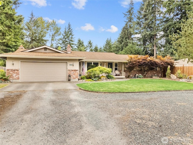 6908 254th St E, Graham, WA 98338 - ranch-style home with brick siding, driveway, a chimney, and an attached garage