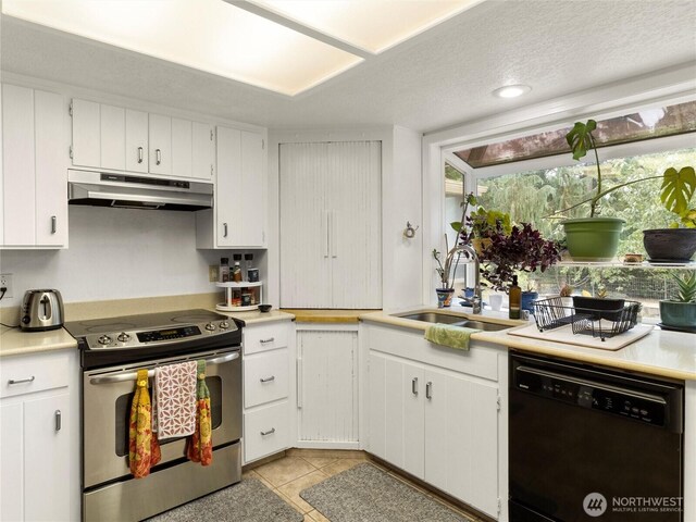 6908 254th St E, Graham, WA 98338 - kitchen with dishwashing machine, electric stove, under cabinet range hood, light countertops, and light tile patterned flooring