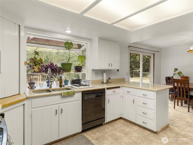 6908 254th St E, Graham, WA 98338 - kitchen featuring black dishwasher, light countertops, light tile patterned floors, and a peninsula