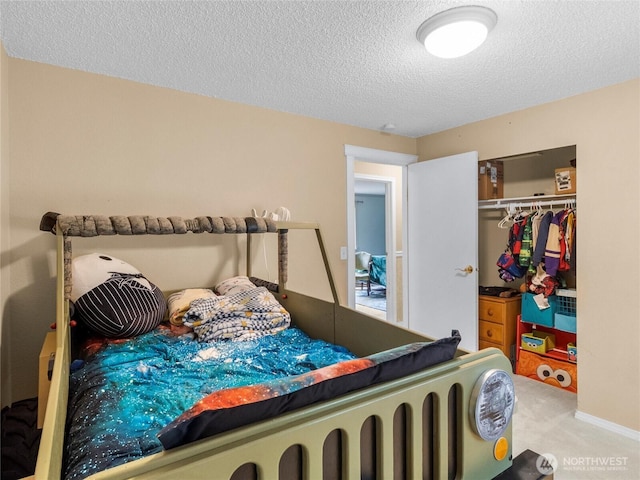 6908 254th St E, Graham, WA 98338 - bedroom featuring a textured ceiling, carpet floors, and a closet