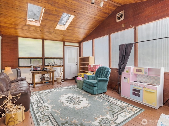 6908 254th St E, Graham, WA 98338 - living room featuring wooden walls, lofted ceiling, wood-type flooring, wooden ceiling, and a skylight