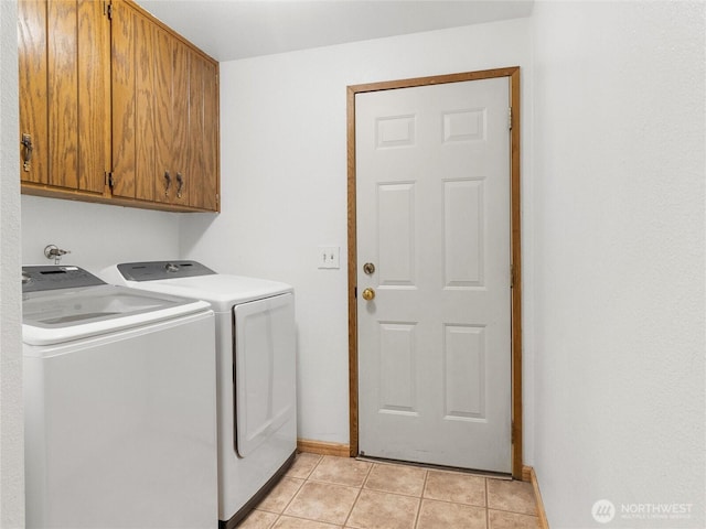 6908 254th St E, Graham, WA 98338 - washroom with cabinet space, washer and clothes dryer, and light tile patterned floors