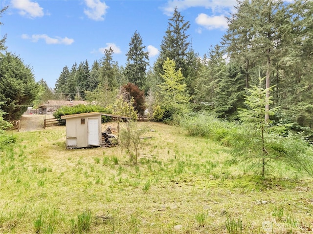 6908 254th St E, Graham, WA 98338 - view of yard featuring a shed and a wooded view