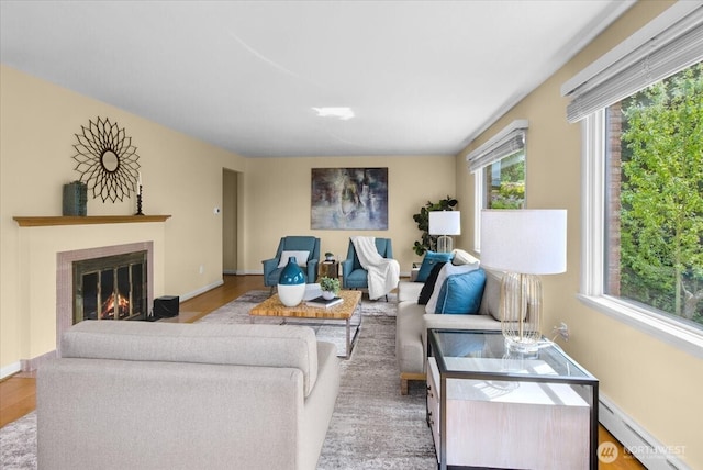 9237 24th Ave NW, Seattle, WA 98117 - living room with baseboard heating, wood finished floors, and a fireplace with flush hearth