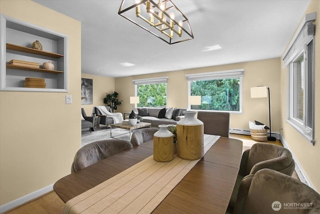 9237 24th Ave NW, Seattle, WA 98117 - dining room featuring wood finished floors, a chandelier, and baseboard heating