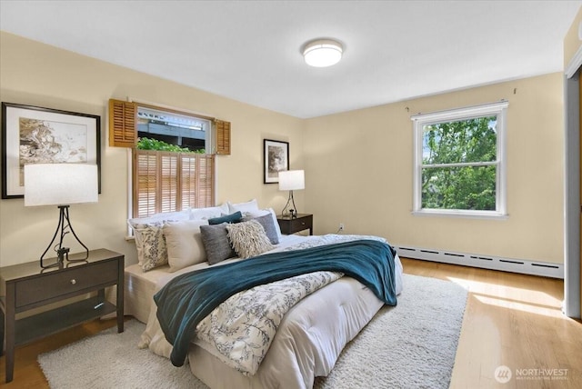 9237 24th Ave NW, Seattle, WA 98117 - bedroom featuring baseboard heating and wood finished floors