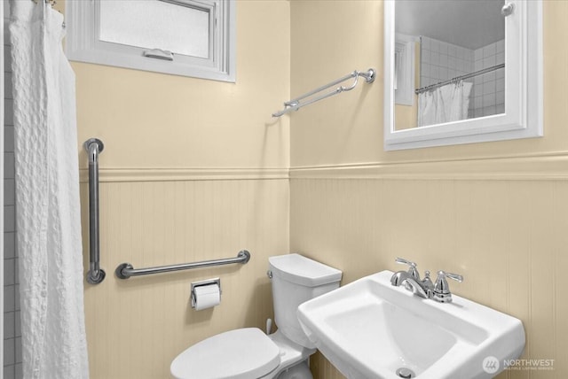 9237 24th Ave NW, Seattle, WA 98117 - full bathroom with wainscoting and a shower with shower curtain