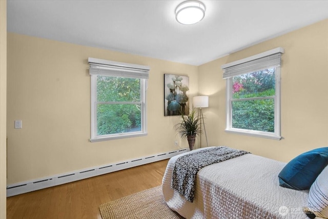 9237 24th Ave NW, Seattle, WA 98117 - bedroom featuring a baseboard radiator and wood finished floors