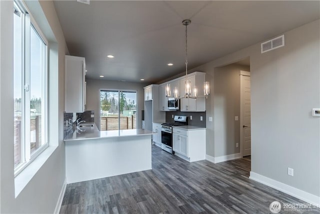 18911 Eagle Ridge Dr E Unit Lt527, Bonney Lake, WA 98391 - kitchen with gas stove, stainless steel microwave, dark wood finished floors, white cabinetry, and recessed lighting