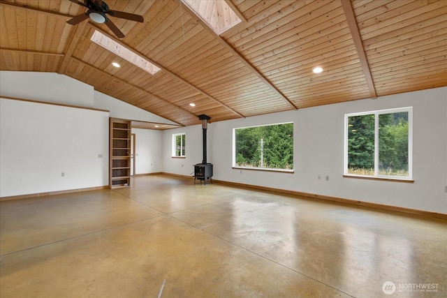 7609 Pressentin Ct, Concrete, WA 98237 - unfurnished room featuring a wood stove, a skylight, finished concrete floors, wooden ceiling, and recessed lighting