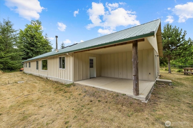 7609 Pressentin Ct, Concrete, WA 98237 - view of property exterior with board and batten siding, a patio, a metal roof, and a yard