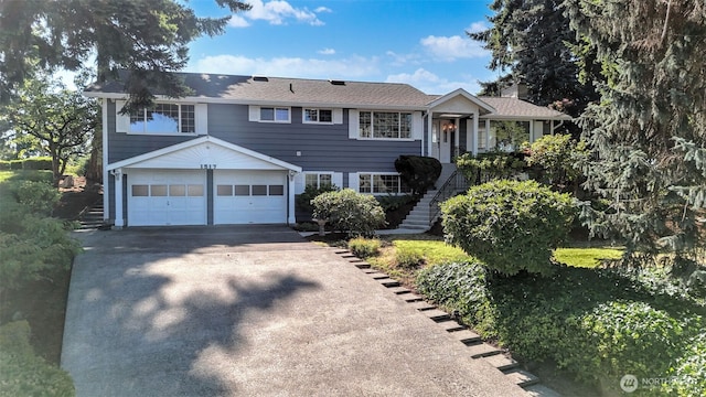 1517 126th Ave E, Edgewood, WA 98372 - view of front of home featuring concrete driveway, a garage, and stairway
