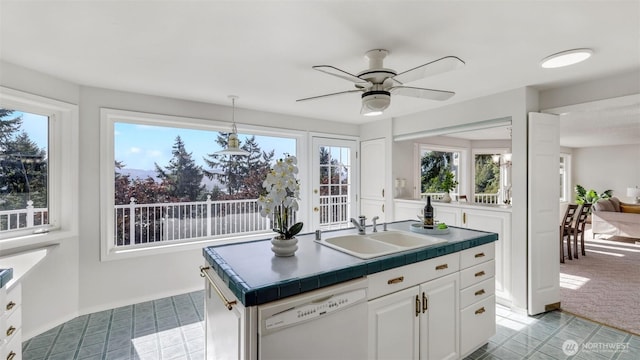 1517 126th Ave E, Edgewood, WA 98372 - kitchen featuring white dishwasher, white cabinets, a ceiling fan, hanging light fixtures, and a kitchen island with sink