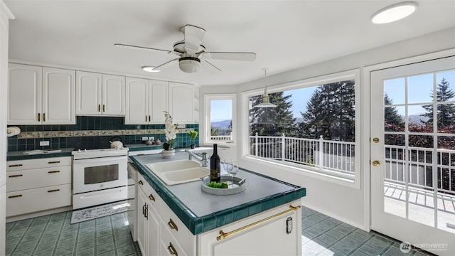1517 126th Ave E, Edgewood, WA 98372 - kitchen featuring white range with electric cooktop, tile counters, and white cabinets