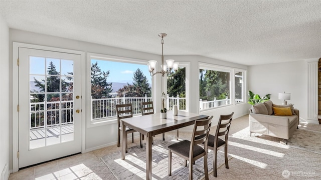 1517 126th Ave E, Edgewood, WA 98372 - dining room featuring a chandelier, healthy amount of natural light, a textured ceiling, and light tile patterned flooring