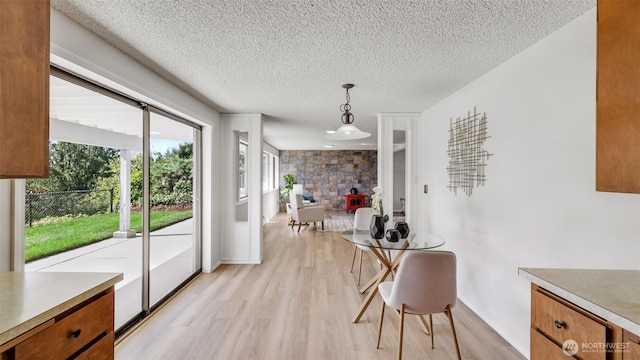 1517 126th Ave E, Edgewood, WA 98372 - dining room with light wood-type flooring and a textured ceiling