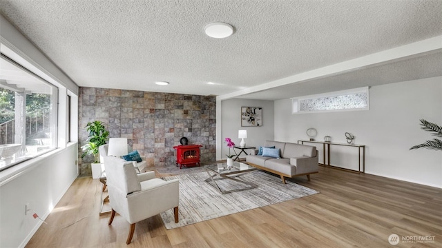 1517 126th Ave E, Edgewood, WA 98372 - living area with a textured ceiling, a wood stove, and wood finished floors