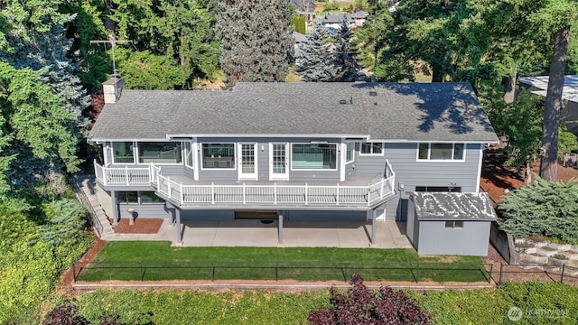 1517 126th Ave E, Edgewood, WA 98372 - rear view of property featuring a patio area, a chimney, a shingled roof, a fenced backyard, and a shed