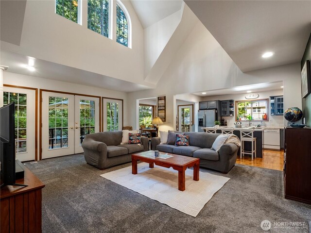 10723 105th Street Ct, Anderson Island, WA 98303 - living area featuring light colored carpet, french doors, a towering ceiling, and recessed lighting