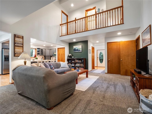 10723 105th Street Ct, Anderson Island, WA 98303 - living area featuring a high ceiling, light colored carpet, and recessed lighting