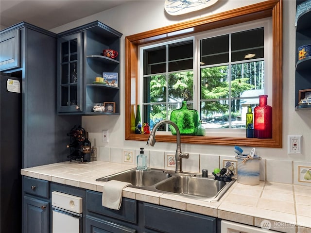 10723 105th Street Ct, Anderson Island, WA 98303 - kitchen featuring fridge, glass insert cabinets, open shelves, and tile countertops