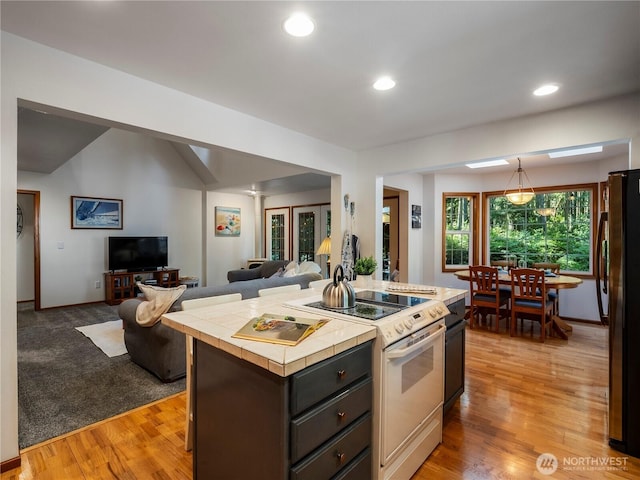 10723 105th Street Ct, Anderson Island, WA 98303 - kitchen featuring tile countertops, electric stove, open floor plan, freestanding refrigerator, and recessed lighting