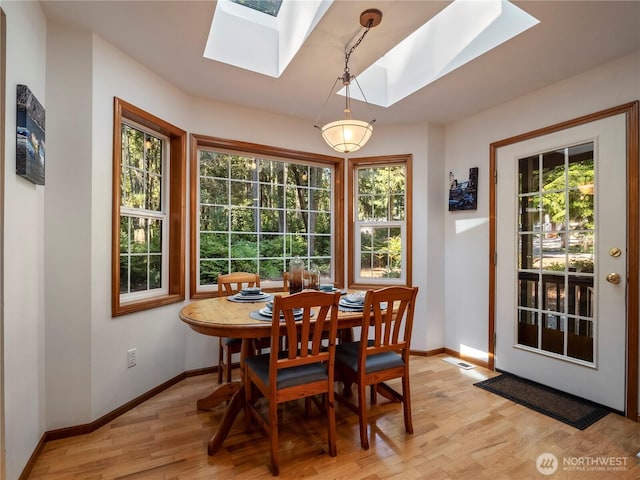 10723 105th Street Ct, Anderson Island, WA 98303 - dining space with a skylight and light wood-type flooring