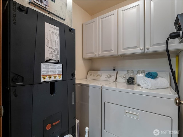 10723 105th Street Ct, Anderson Island, WA 98303 - laundry area featuring heating unit, cabinet space, and washing machine and dryer