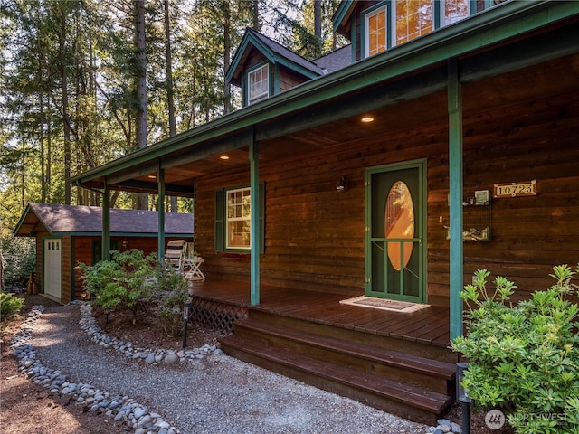 10723 105th Street Ct, Anderson Island, WA 98303 - view of side of home featuring covered porch and a shingled roof