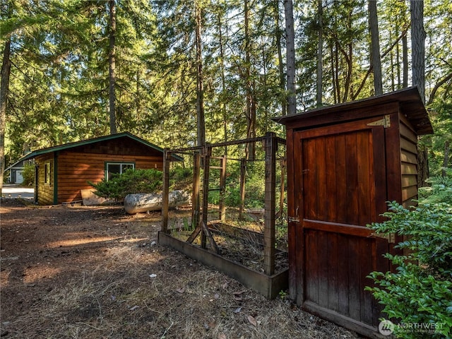 10723 105th Street Ct, Anderson Island, WA 98303 - gate with an outbuilding and a vegetable garden