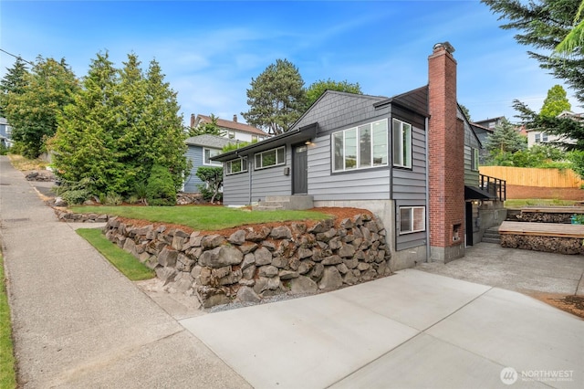 4130 Palatine Ave N, Seattle, WA 98103 - view of front of house with a chimney and a patio