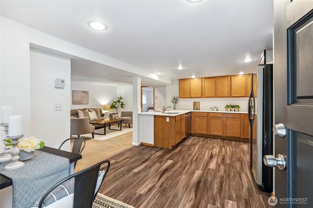 4130 Palatine Ave N, Seattle, WA 98103 - kitchen featuring appliances with stainless steel finishes, dark wood finished floors, light countertops, recessed lighting, and brown cabinetry