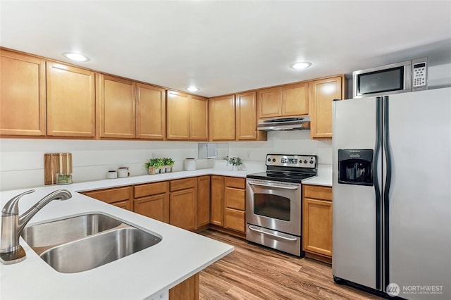 4130 Palatine Ave N, Seattle, WA 98103 - kitchen featuring stainless steel appliances, under cabinet range hood, light countertops, light wood finished floors, and recessed lighting