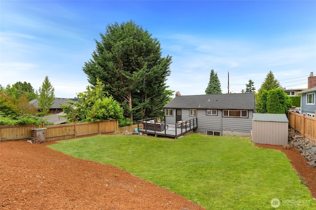 4130 Palatine Ave N, Seattle, WA 98103 - rear view of house featuring a fenced backyard, a storage unit, and a wooden deck