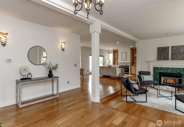 29851 12th Ave SW, Federal Way, WA 98023 - living room with a tile fireplace, decorative columns, wood finished floors, a chandelier, and recessed lighting