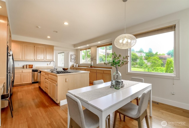 29851 12th Ave SW, Federal Way, WA 98023 - kitchen with light brown cabinets, recessed lighting, a center island with sink, light wood-style floors, and light countertops