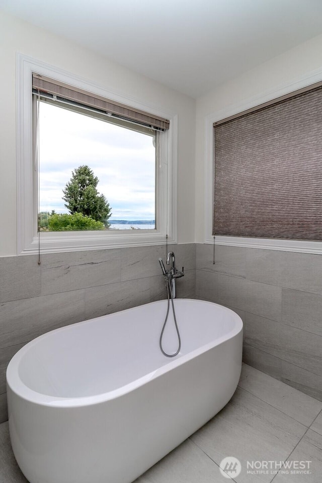 29851 12th Ave SW, Federal Way, WA 98023 - full bathroom featuring tile walls, a freestanding tub, and a wainscoted wall
