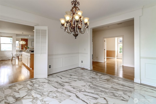 29851 12th Ave SW, Federal Way, WA 98023 - unfurnished room featuring healthy amount of natural light, a wainscoted wall, a chandelier, light marble finish floors, and crown molding