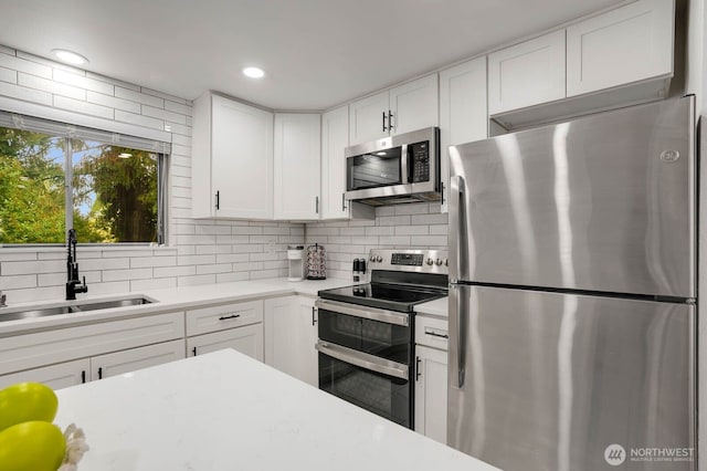 2536 S 286th St, Federal Way, WA 98003 - kitchen featuring appliances with stainless steel finishes, decorative backsplash, light countertops, white cabinetry, and recessed lighting
