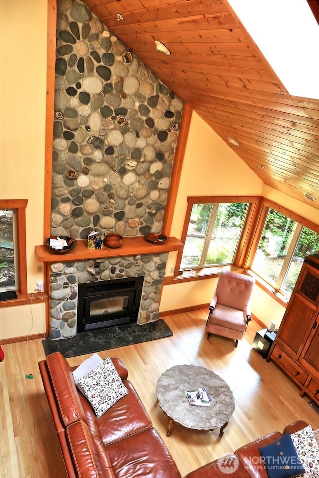 22307 E Lost Lake Rd, Snohomish, WA 98296 - living area with lofted ceiling, wood ceiling, a fireplace, and wood finished floors
