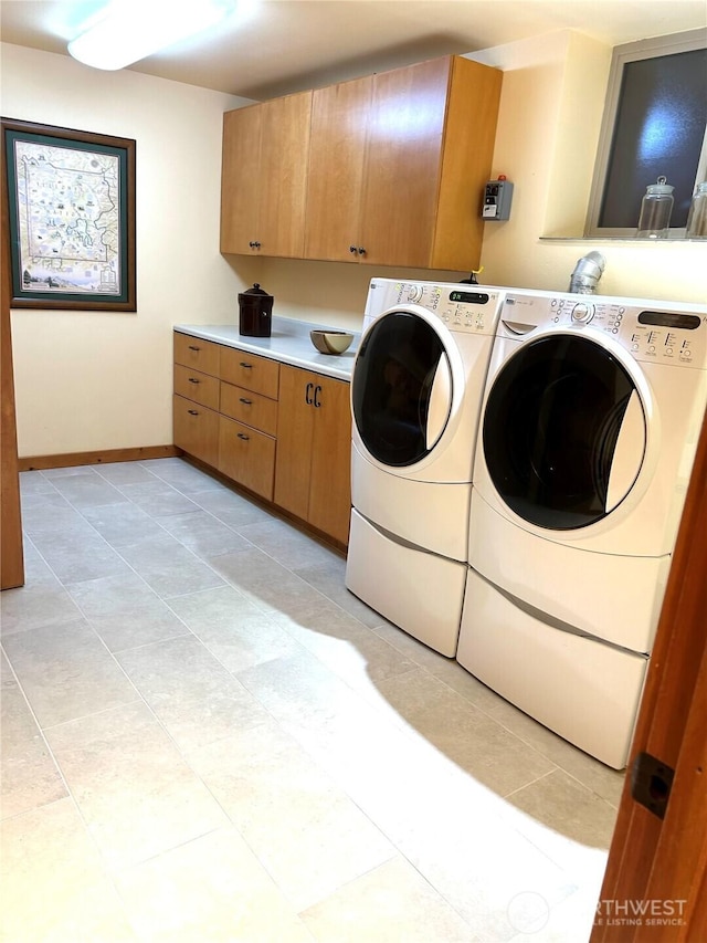 22307 E Lost Lake Rd, Snohomish, WA 98296 - laundry area featuring cabinet space, washing machine and dryer, and light tile patterned flooring